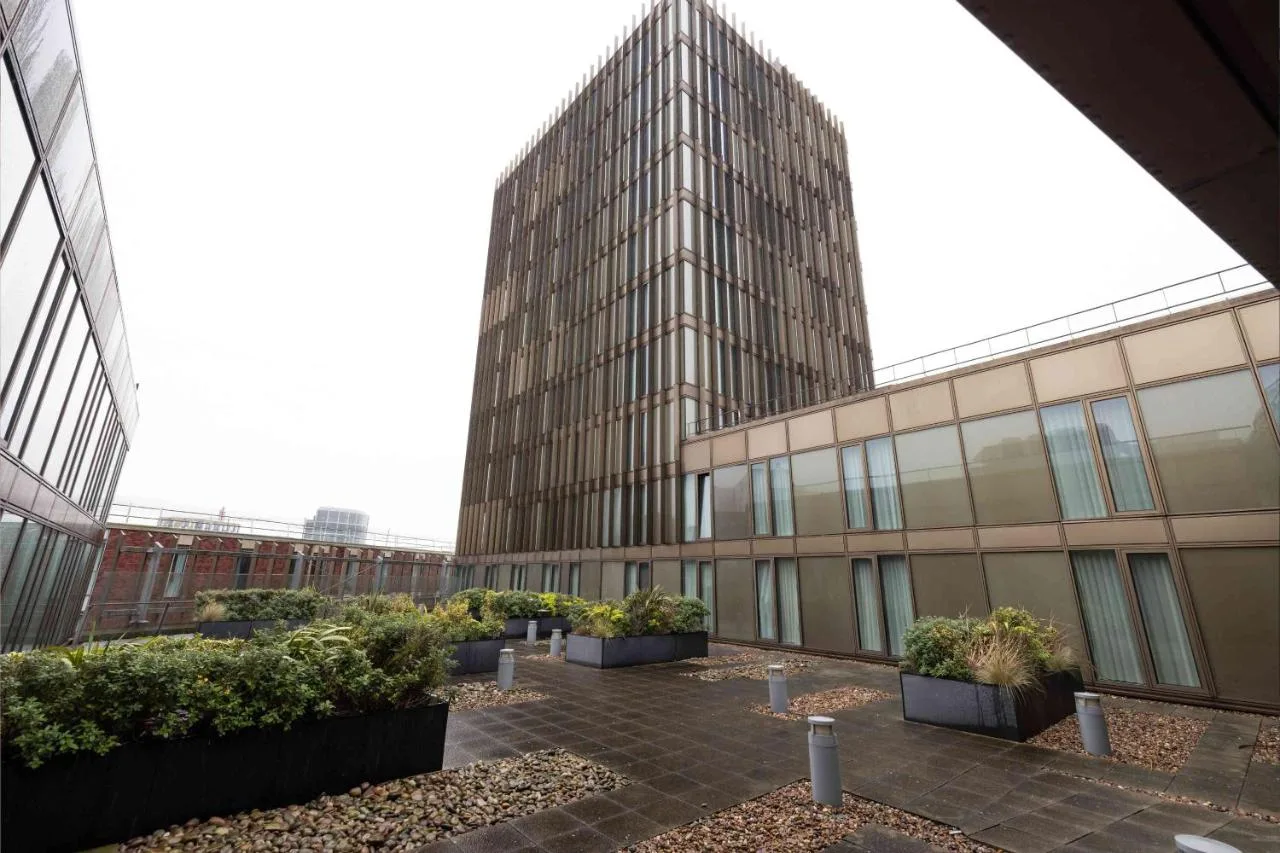 a large building with some plants in a courtyard at Cove Paradise Street in Liverpool